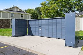 Michigan City apartment for rent - A large blue gate with a smaller black gate in front of a house.
