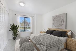 Elkhart apartment for rent - A bedroom with a large bed and a large window with a view at North Pointe Apartments, Elkhart
