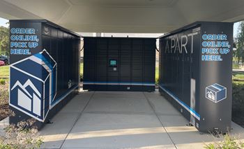 A pair of black lockers with white and blue lettering and a blue and white sign