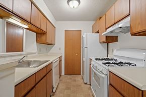 Rockford apartment for rent - a kitchen with white appliances and wooden cabinets at Beacon Hill and Great Oaks Apartments, Illinois