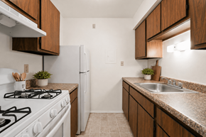 Waterford Twp apartment for rent - A kitchen with a white gas stove and a white refrigerator.