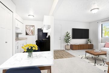 Wyoming apartment for rent - A living room with a white table and a blue chair.
