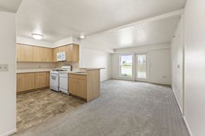Kalamazoo apartment for rent - A kitchen with wooden cabinets and a white dishwasher at Tall Oaks Apartment Homes, Michigan, 49009