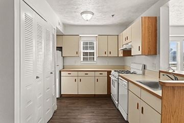 Kalamazoo apartment for rent - A kitchen with white cabinets and a window.