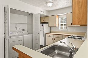 Kalamazoo apartment for rent - A kitchen with a washer and dryer at Tall Oaks Apartment Homes, Michigan, 49009