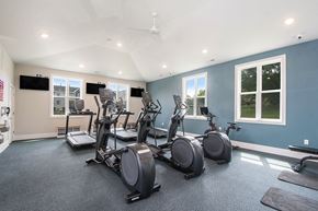 Grand Rapids apartment for rent - fitness center with plenty of cardio equipment and windows at The Crossings Apartments, Michigan, 49508