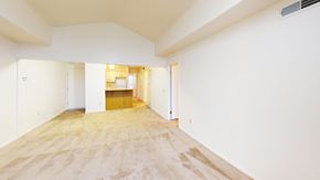 Perrysburg apartment for rent - A spacious living room with a cathedral ceiling and plush carpet at Tracy Creek Apartment Homes in Perrysburg, OH