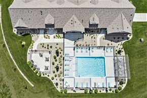 Elkhorn apartment for rent - A drone view of a pool with seating and a grilling area at Trade Winds Apartment Homes in Elkhorn, NE 68022
