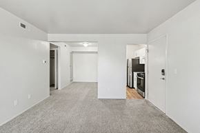 Lansing apartment for rent - A spacious, empty dining room with a breakfast bar at Trappers Cove Apartments, Lansing