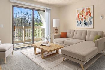 A living room with a blue couch, and a slider to a private balcony