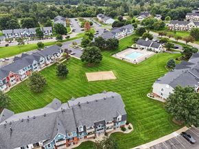 Portage apartment for rent - A bird's eye view of a residential area with apartment buildings, a swimming pool, and a parking lot at Walnut Trail Apartments, Michigan