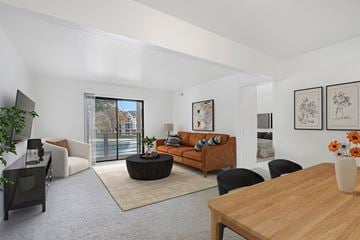 Holland apartment for rent - A living room with a brown sofa and a wooden table.
