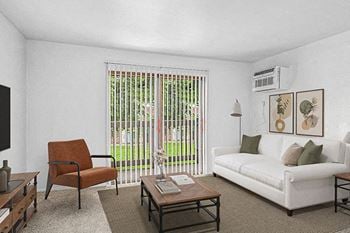 A living room with a white couch, and a slider to a private balcony