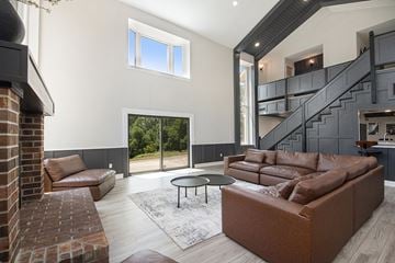 Kentwood apartment for rent - A living room with a brown couch and a brick fireplace.