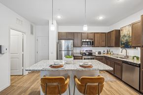 Tampa apartment for rent - A modern kitchen with a granite countertop and stainless steel appliances.