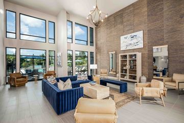 Gainesville apartment for rent - A living room with a blue couch and a chandelier.