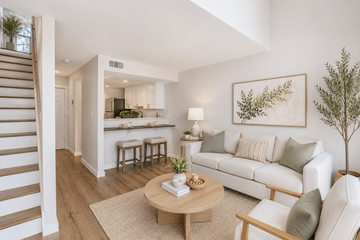 Gainesville townhouse for rent - A living room with a white couch, a wooden coffee table, and a painting on the wall.
