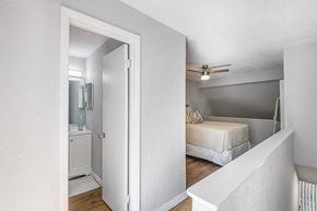 Gainesville townhouse for rent - a bedroom with a bed and a ceiling fan