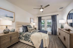 Gainesville apartment for rent - A bedroom with a bed, nightstands, and a ceiling fan.