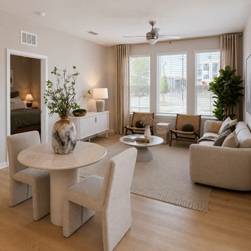 Gainesville apartment for rent - A living room with a round table and chairs, a sofa, and a ceiling fan.