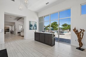 Tampa apartment for rent - A modern house interior with a pool visible through the windows.