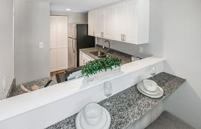 Gainesville townhouse for rent - a kitchen with granite counter tops and white cabinets