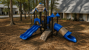 Gainesville townhouse for rent - A playground with a blue slide and a brown sandbox.