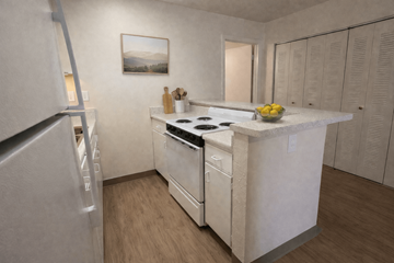 Gainesville apartment for rent - A kitchen with a white counter top and a fridge on the left.