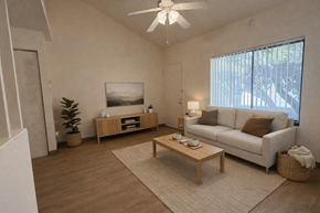 Gainesville apartment for rent - A living room with a white couch, a wooden coffee table, and a ceiling fan.