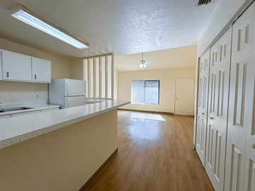 Gainesville apartment for rent - A kitchen with white cabinets and a refrigerator.