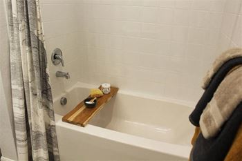 Spacious soaking tub with curved shower rod