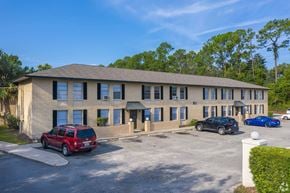 Jacksonville apartment for rent - A building with a parking lot in front of it.