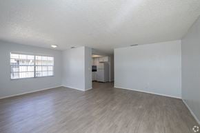 St. Petersburg apartment for rent - A spacious room with wooden flooring and white walls.
