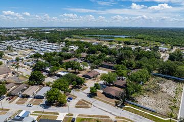 St. Petersburg apartment for rent - A bird's eye view of a residential area with houses, trees, and a parking lot.