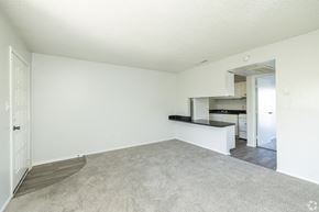 Largo apartment for rent - A spacious living room with a carpeted floor and white walls.