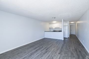 Pinellas Park apartment for rent - A kitchen area with white cabinets and a refrigerator.