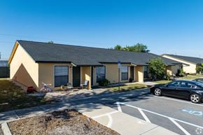 Pinellas Park apartment for rent - A small building with a car parked in front.