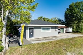 Pinellas Park apartment for rent - A house with a grey roof and a yellow umbrella in front.