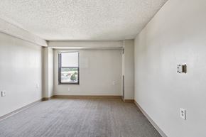 Kansas City apartment for rent - A room with a carpeted floor and a window.