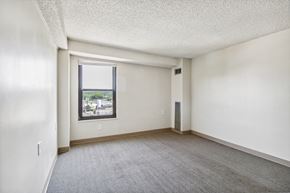 Kansas City apartment for rent - A room with a window and a carpeted floor.