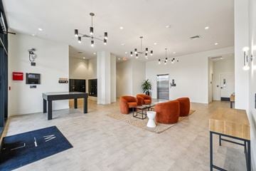 Detroit apartment for rent - A modern living room with a pool table and a TV.