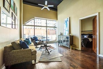 Oklahoma City apartment for rent - A living room with a couch and a fan.