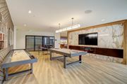 Detroit apartment for rent - a game room with two ping pong tables and a television