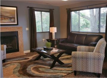 Brighton apartment for rent - a living room with leather furniture and a fireplace