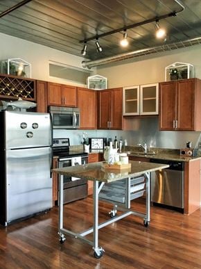 Ann Arbor apartment for rent - a kitchen with stainless steel appliances and a table at Ann Arbor City Club, Ann Arbor