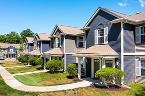 Lansing apartment for rent - the view of a row of suburban homes on a sidewalk