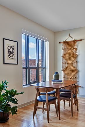 Detroit apartment for rent - a dining room with a large window and a wooden table and chairs