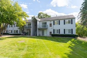 Waterford apartment for rent - white apartment building with green grass and trees