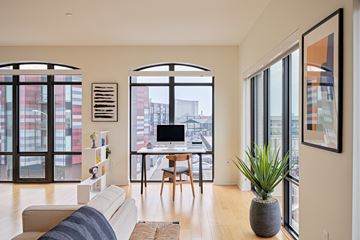 Detroit apartment for rent - a living area with a couch and a desk with a computer