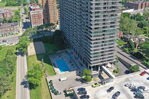 Detroit apartment for rent - Image of the pool at the Jefferson. There is a green grass courtyard next to the pool.